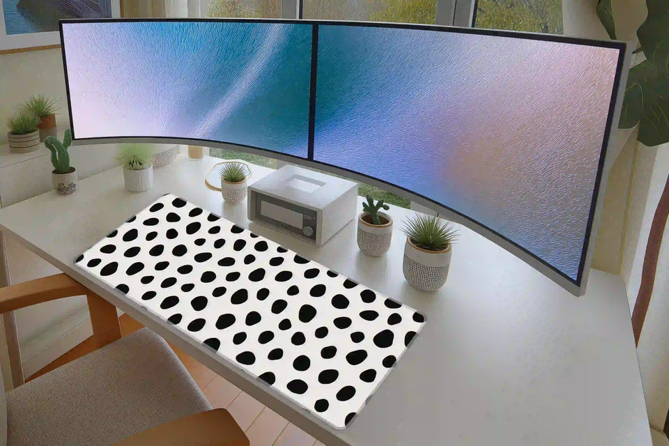 Keyboard and mouse layout on the Dalmatian Spots desk mat for a gaming setup