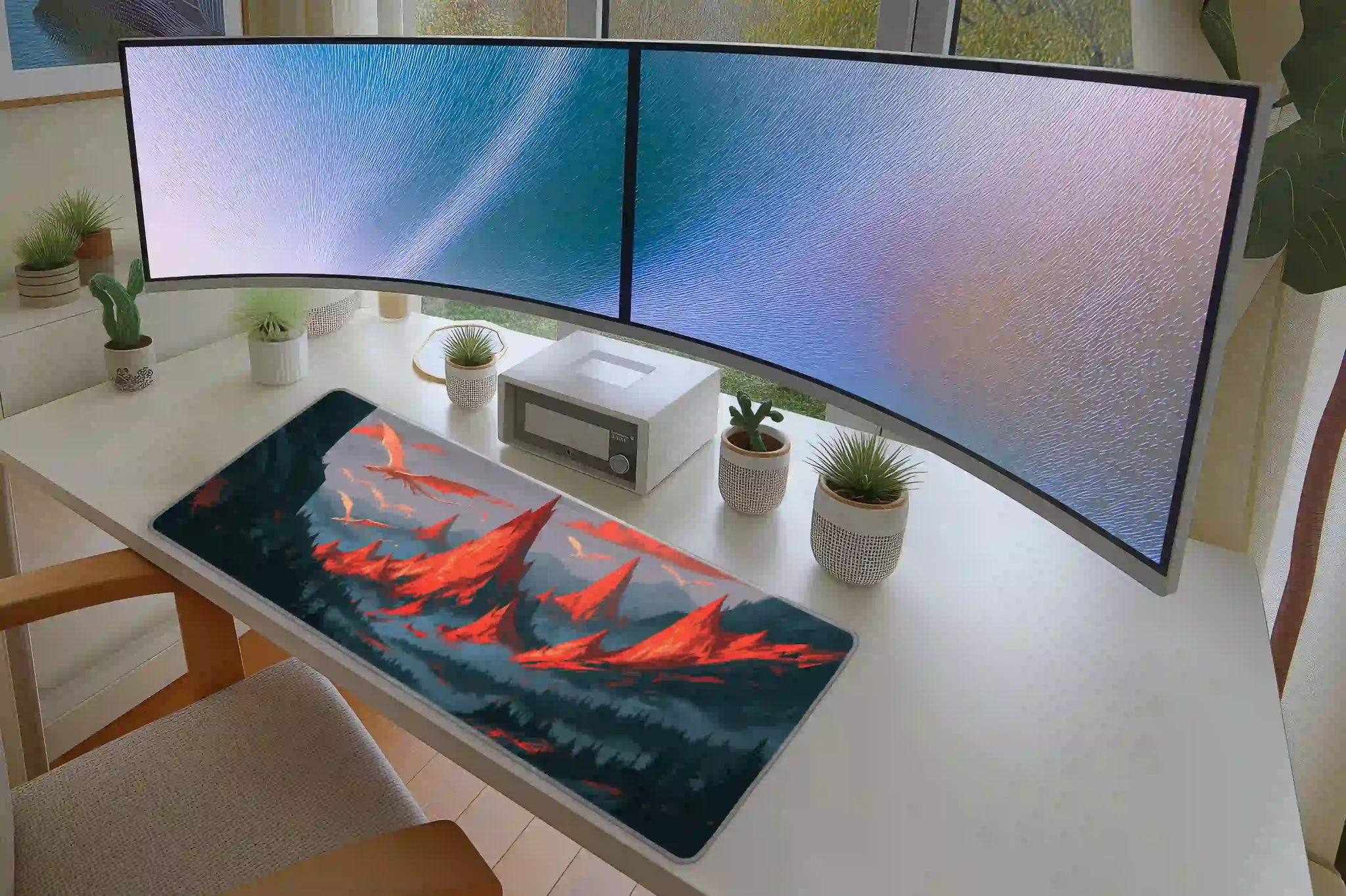 Keyboard and mouse layout on the White Dragon Mountain desk mat for a gaming setup