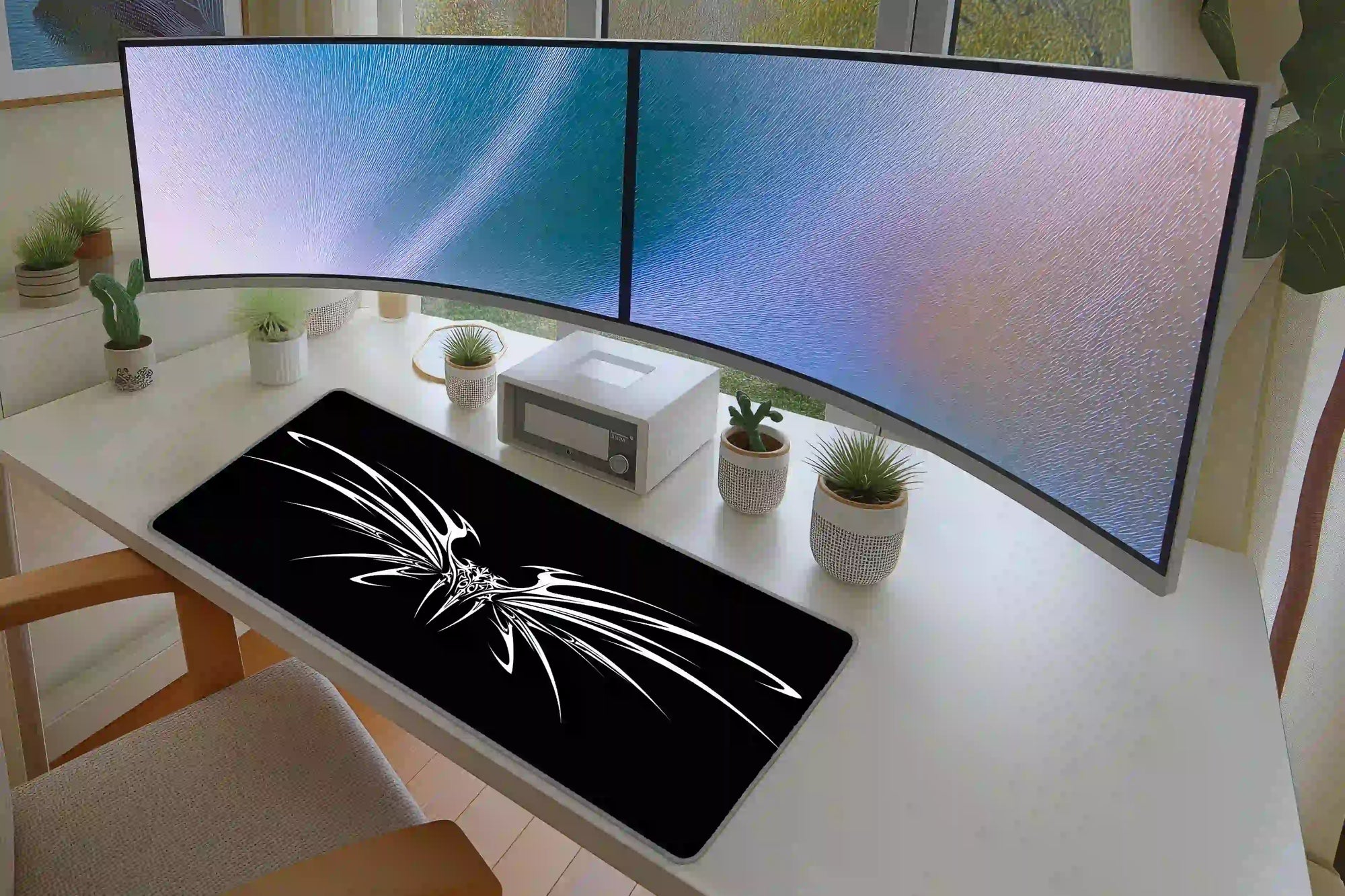 Office desk setup featuring the black and white cyber tribal wings extended mouse pad