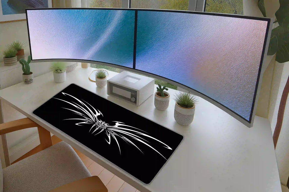 Office desk setup featuring the black and white cyber tribal wings extended mouse pad