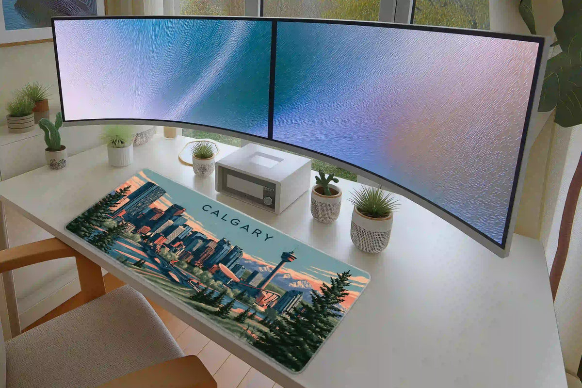 Calgary desk mat in a full office desk setup on a white desk below dual curved monitors