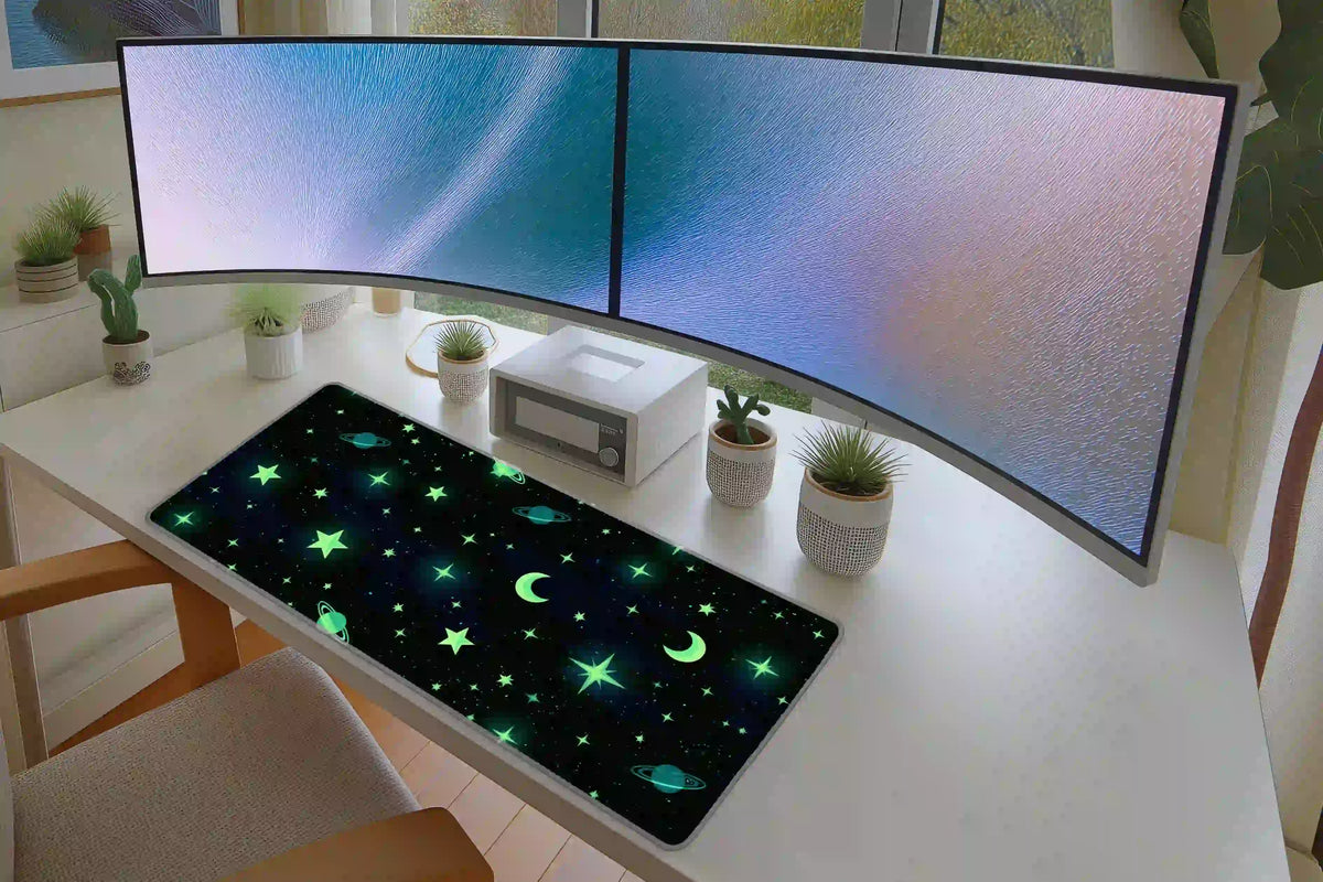 Green celestial stars and moon desk mat displayed on a white desk with dual monitors and small plants