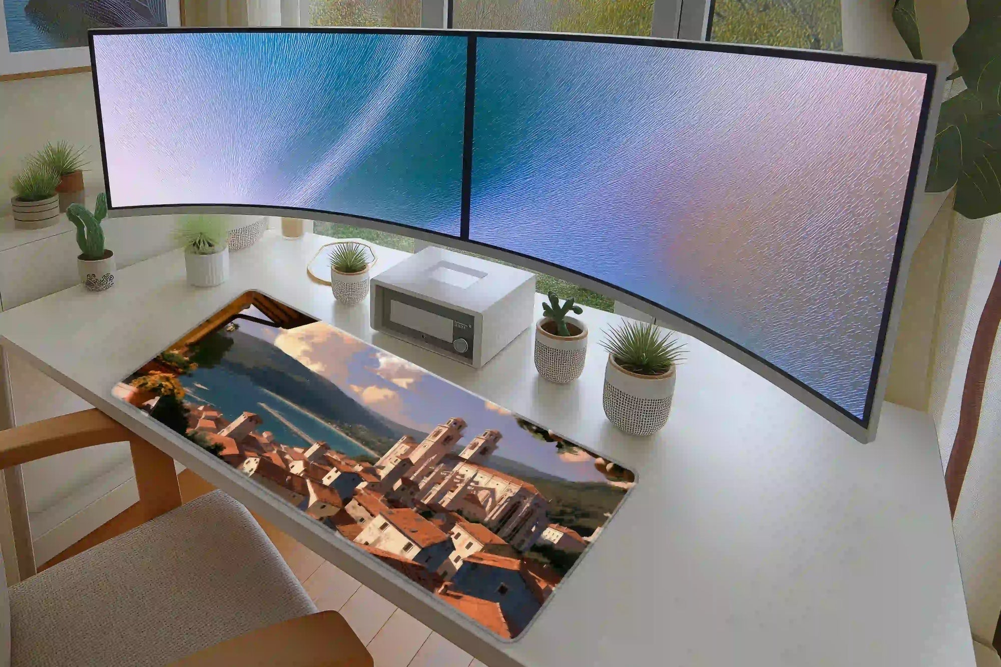 Keyboard and mouse layout on the Mediterranean Village desk mat for a gaming setup