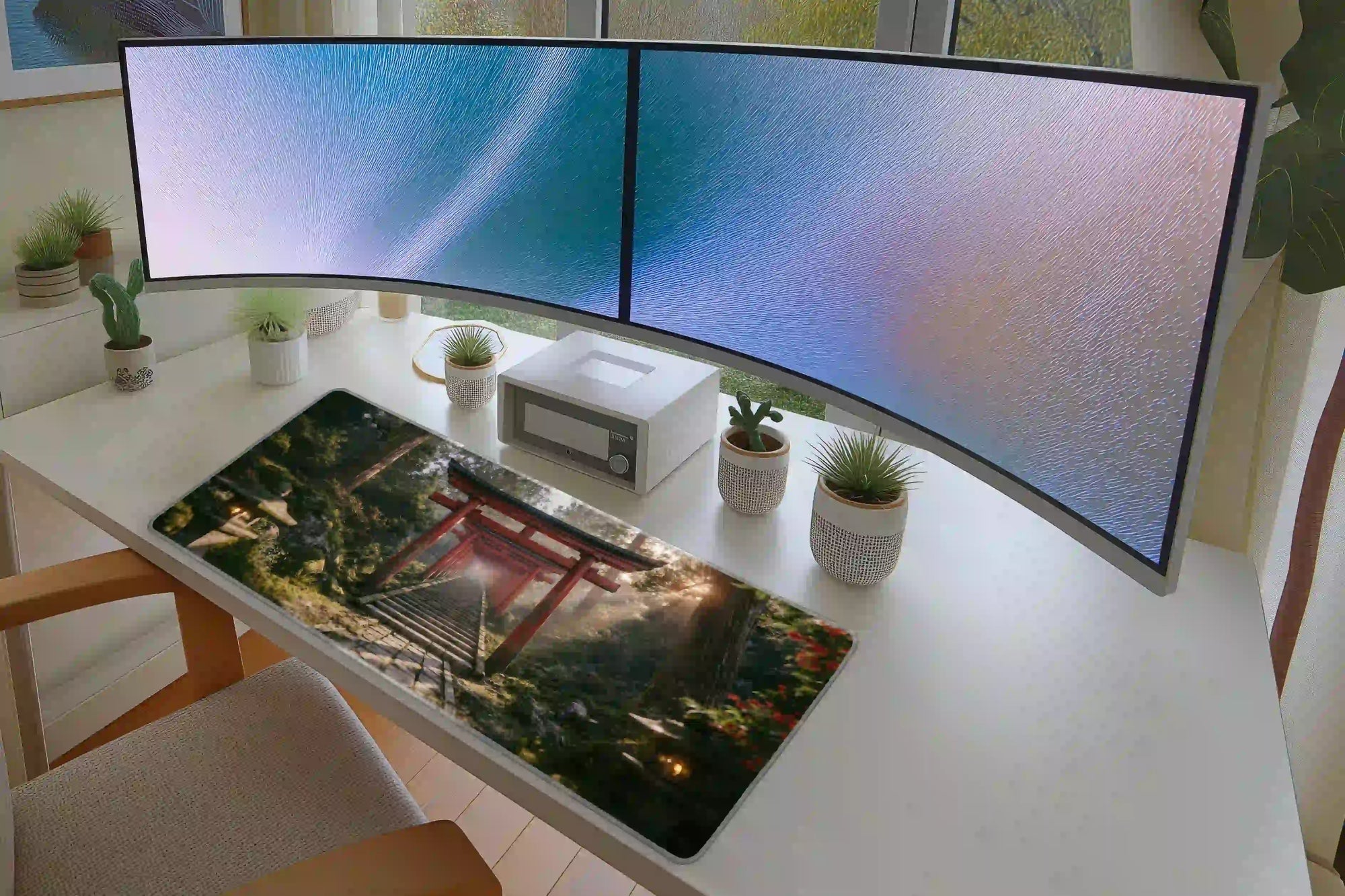 Keyboard and mouse layout on the Torii Gate Forest desk mat for a gaming setup