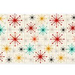 Wide view of the Mid Century Atomic Starburst desk mat featuring atomic starbursts and a geometric grid