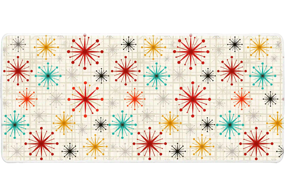 Wide view of the Mid Century Atomic Starburst desk mat featuring atomic starbursts and a geometric grid