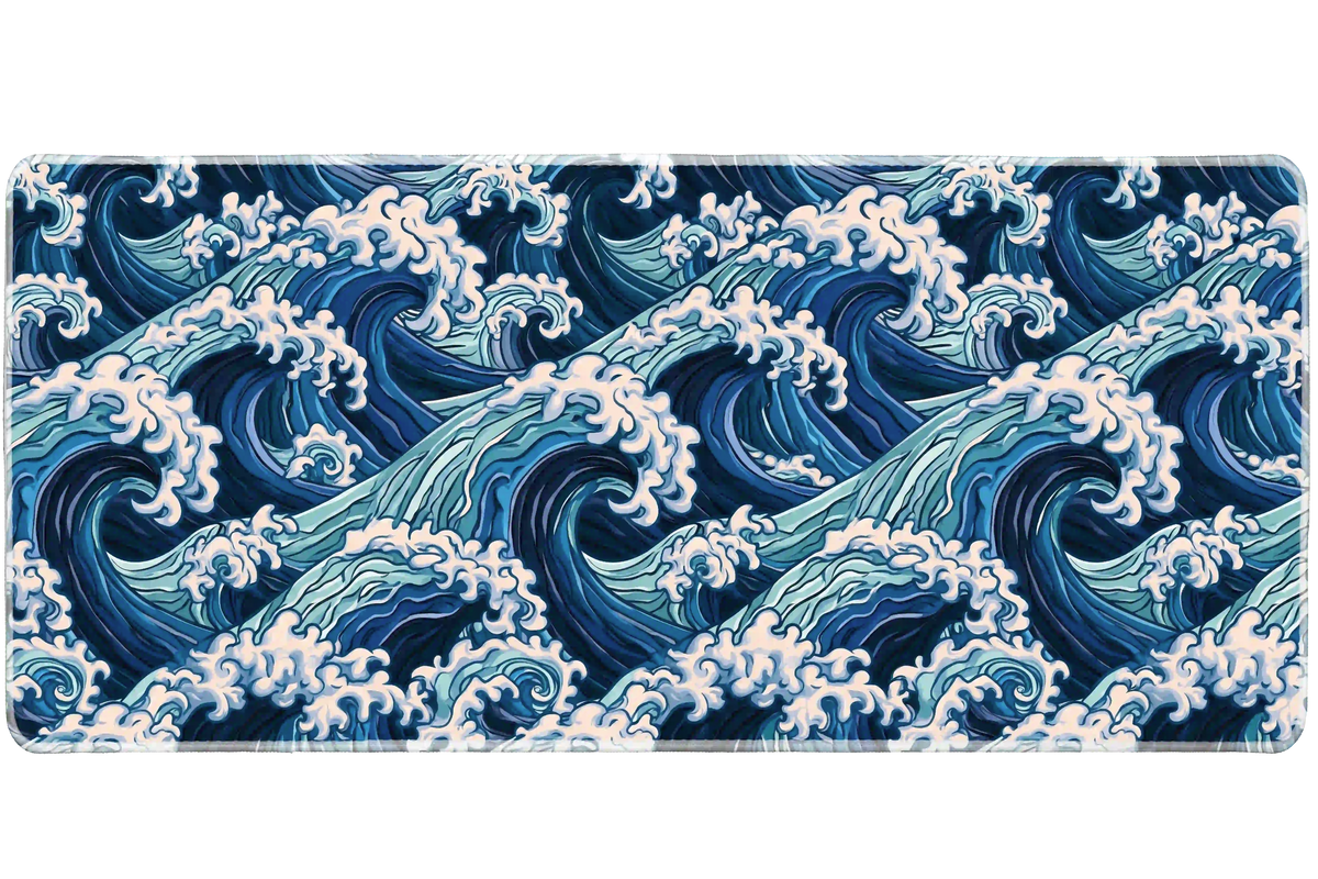Blue ocean wave desk mat covered in repeating navy and aqua curls with pale foamy crests