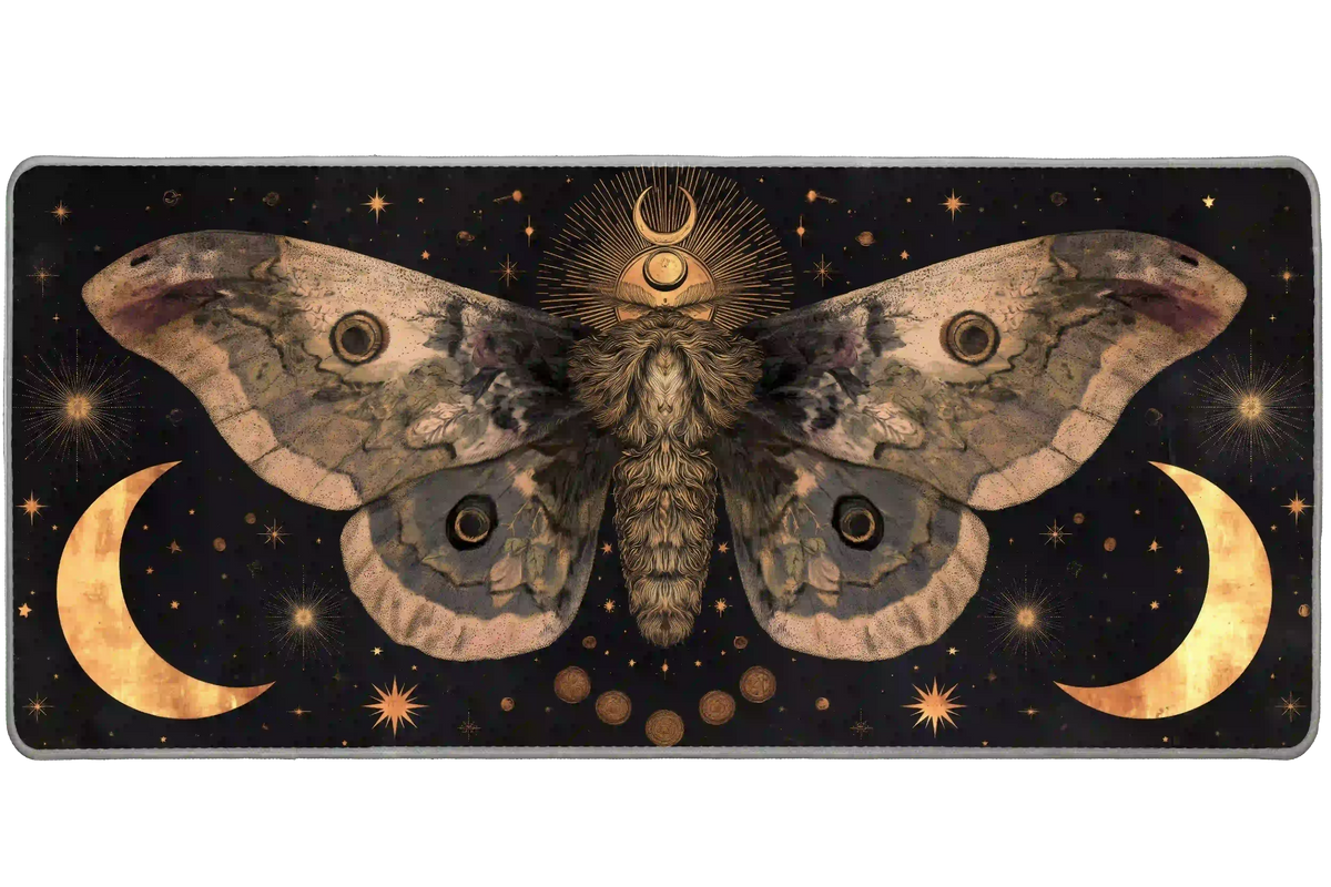 Celestial desk mat with a large sepia moth, golden crescent moons and starbursts against a black background