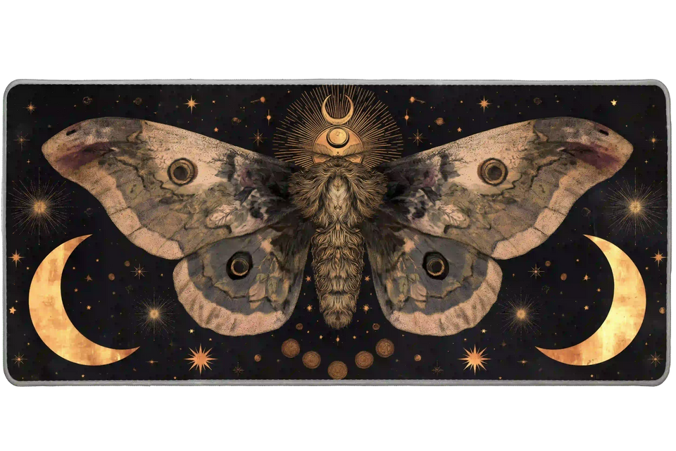 Celestial desk mat with a large sepia moth, golden crescent moons and starbursts against a black background