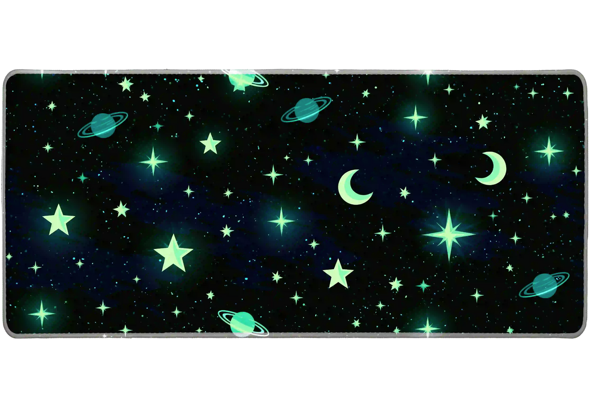 Celestial desk mat with mint-green stars, crescent moons and teal ringed planets on a dark blue-black sky
