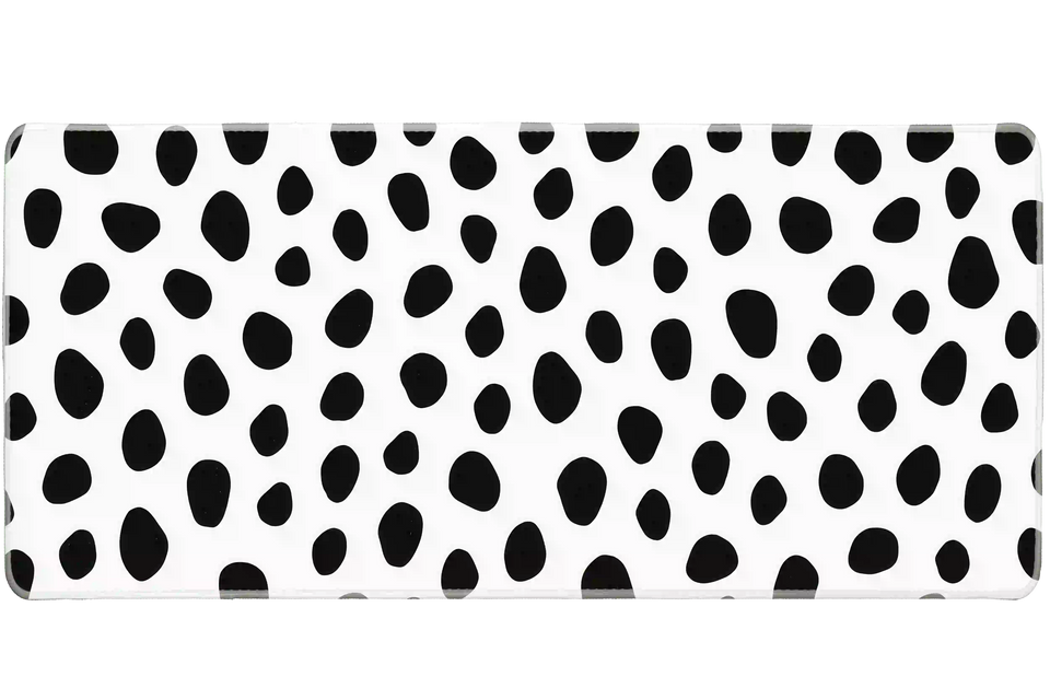Overhead Dalmatian Spots desk mat view with irregular black animal spots on a crisp white field