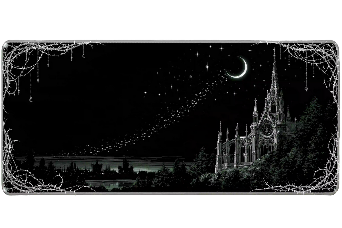 Moonlit gothic cathedral desk mat with fine pale spires, a crescent moon and an ornate thorn border on black