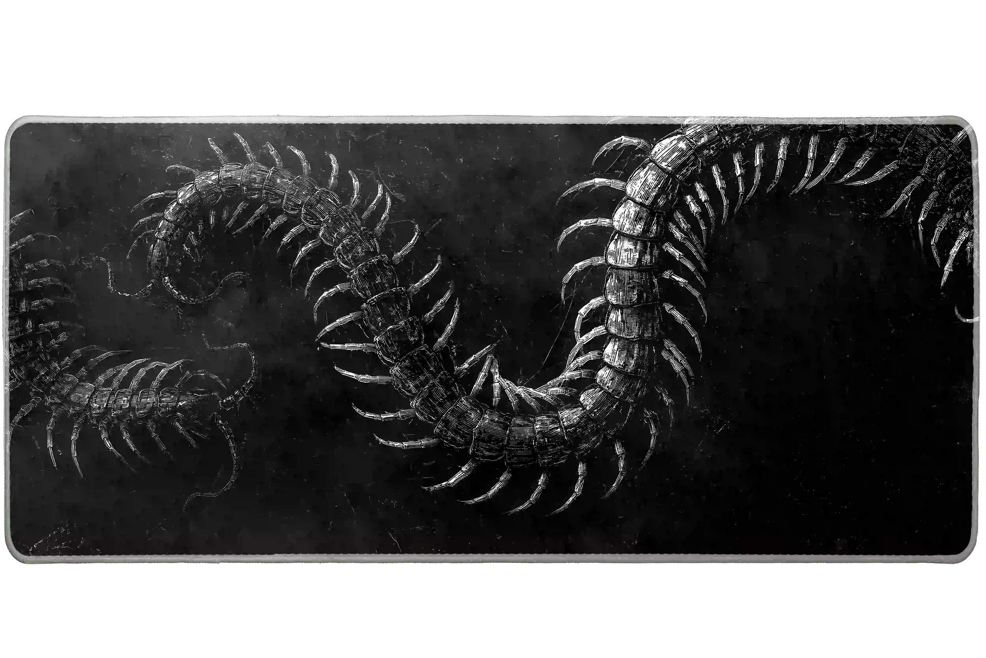 Gothic Centipede desk mat product view highlighting engraved white centipedes twisting across distressed black