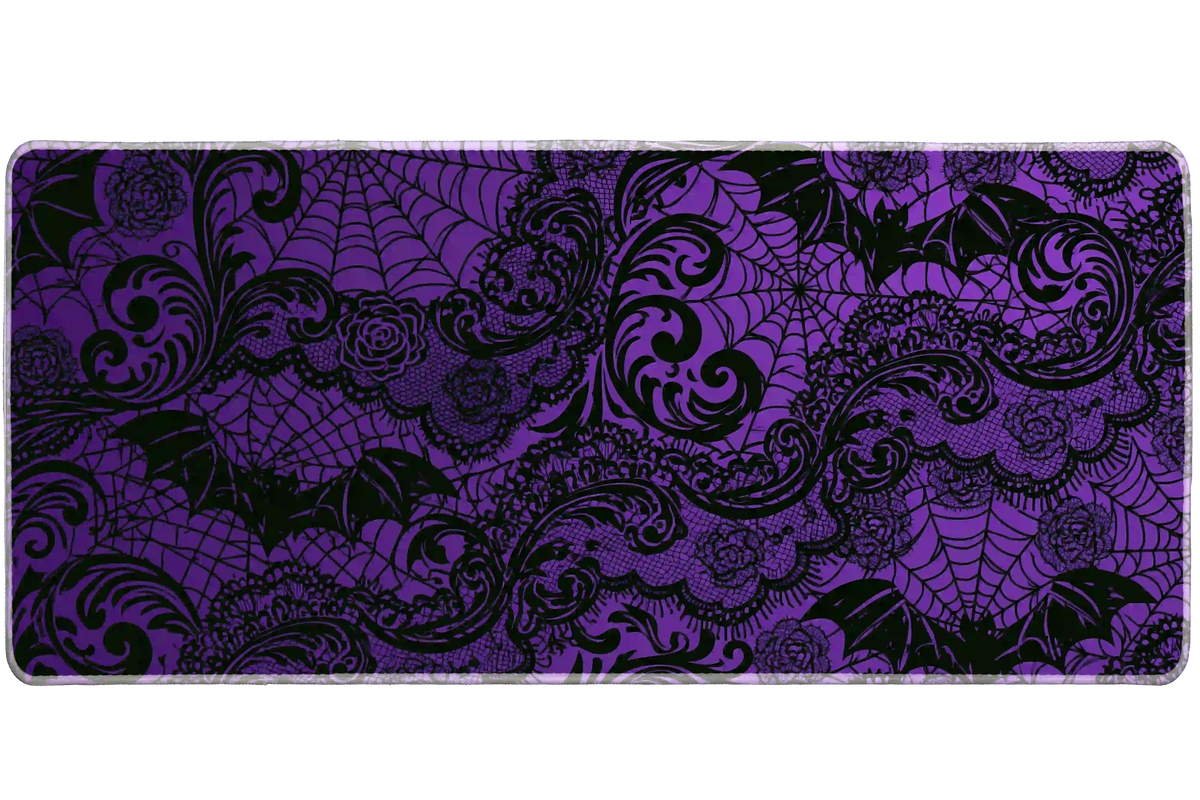 Purple and black gothic desk mat with bat silhouettes, roses, spiderwebs and ornate printed lace scrollwork