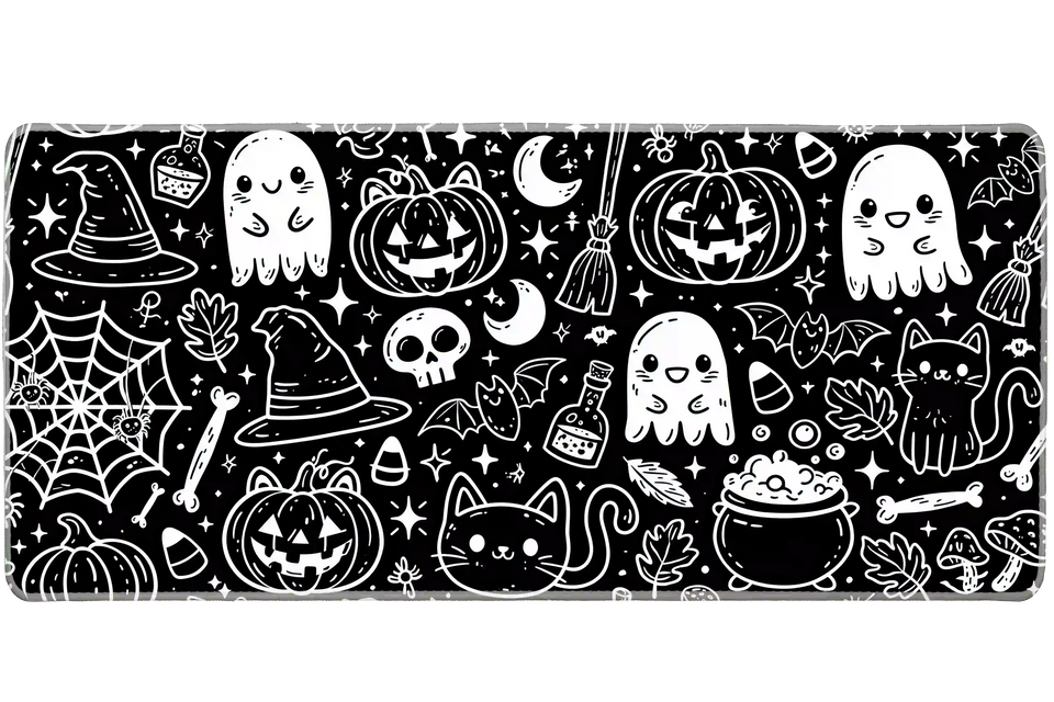 Black and white Halloween doodle desk mat with smiling ghosts, cats, pumpkins, bats, witch hats and potion bottles