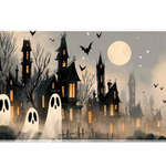 Haunted village desk mat with cream ghosts, black houses, glowing orange windows and a full moon in gray fog
