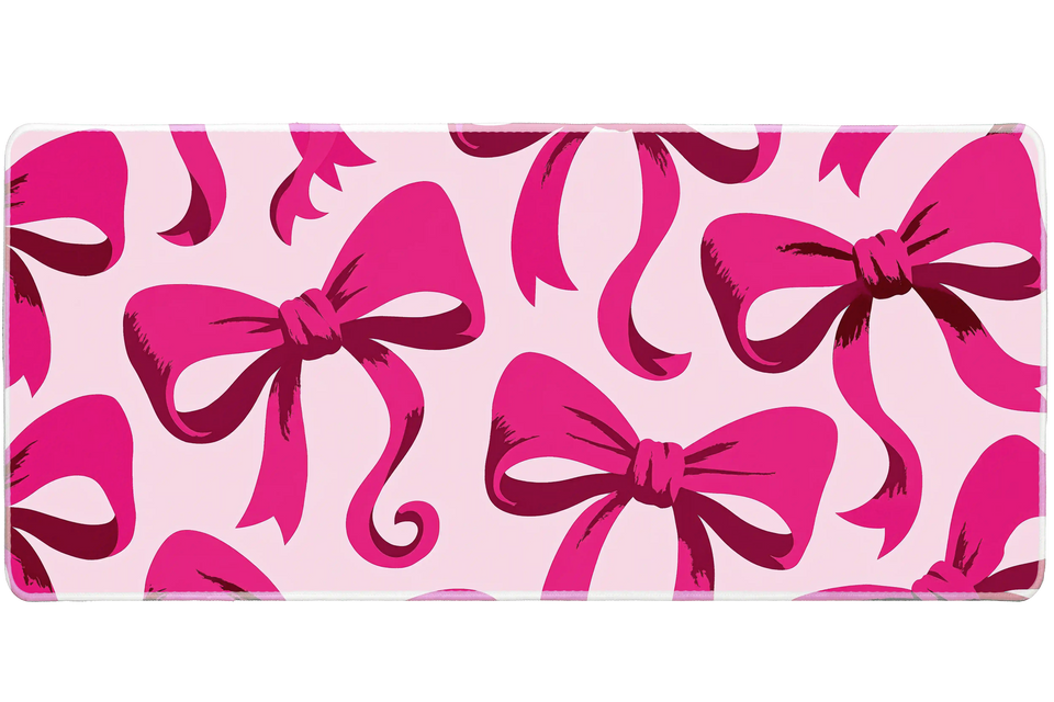 Hot Pink Bow Oversized Ribbon desk mat with oversized ribbon artwork on a soft pink background