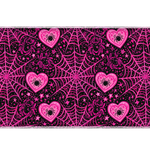 Black and hot pink desk mat patterned with spiderwebs, spiders inside hearts and scattered stars