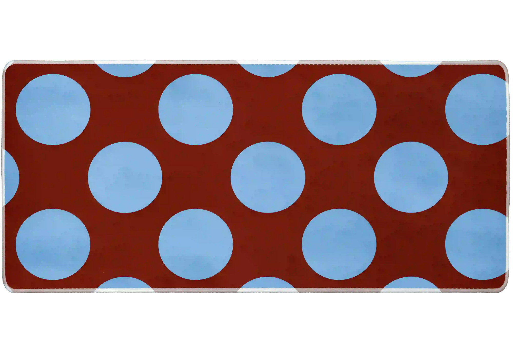 Wide Retro Polka Dot desk mat with powder-blue circles across a warm rust-red field