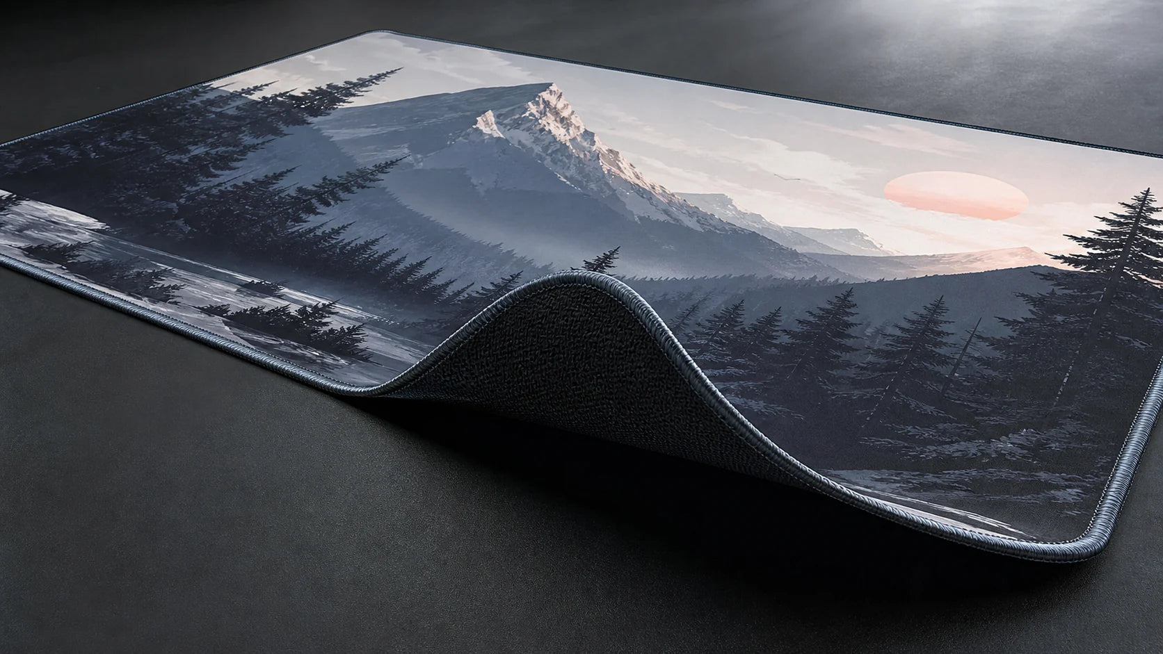 Custom desk mat corner lifted to show printed fabric, stitched edge, and rubber underside